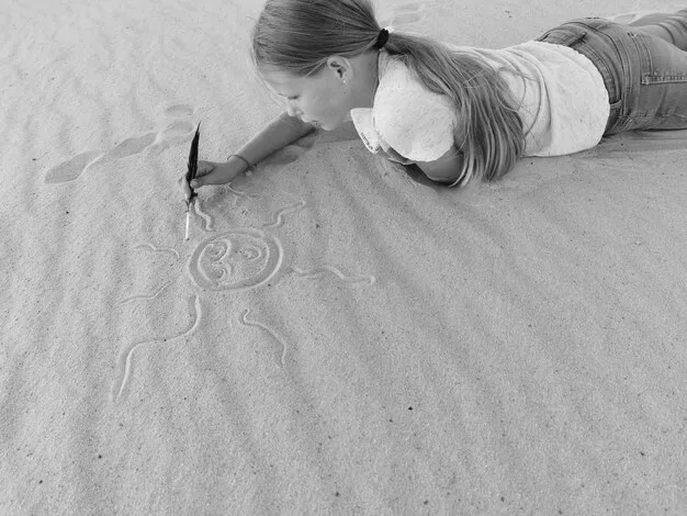 A person drawing a boundary line in the sand as the waves gently approach. The scene symbolizes setting personal limits and protecting one's space and well-being.