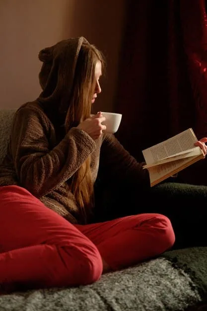 A person sitting in a cozy armchair, surrounded by books, a cup of tea, and a journal. The atmosphere is warm and inviting, encouraging viewers to reflect on their inner thoughts and feelings.