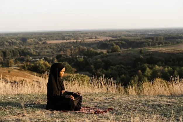 A person sitting peacefully outdoors, eyes closed, hands resting on knees, engaged in mindful meditation. The background shows a serene natural setting.