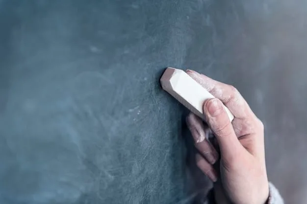 A hand holding an eraser, erasing negative words written on a chalkboard. The words being erased include