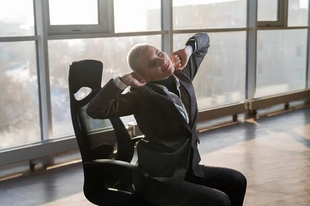 A person sitting in an office chair, performing a neck roll by tilting their head gently to the side. The background shows a typical office environment.
