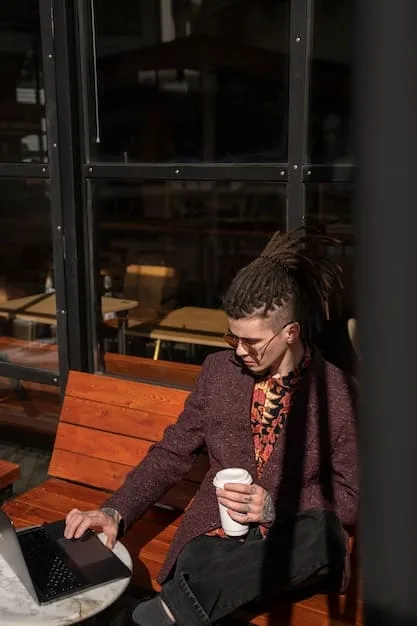 A person sitting alone in a coffee shop, typing on a laptop. The scene is thoughtful and introspective, suggesting the importance of self-reflection and vulnerability in building connections.