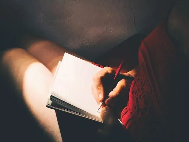 A close-up of a hand writing in a journal. The lighting is soft, and the focus is on the pen and paper. The background is slightly blurred, suggesting a calm, reflective environment.