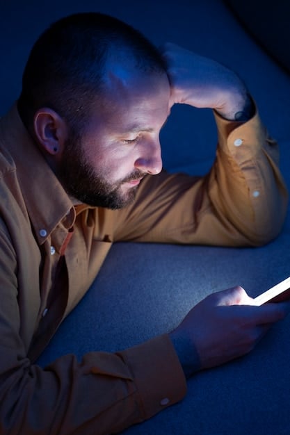 A close-up shot of a worried individual scrolling through social media on their phone at night.