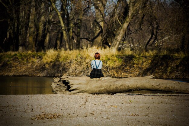 A person meditating in a peaceful environment, surrounded by nature. The scene is calm and serene, promoting relaxation and emotional balance.
