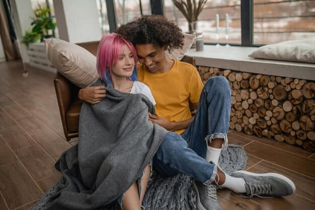 Two people sitting on a couch, deep in conversation, with one person comforting the other with a hand on their shoulder. The setting is a cozy living room, emphasizing trust and empathy.