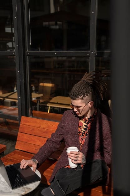 A person sitting alone in a coffee shop, typing on a laptop. The scene is thoughtful and introspective, suggesting the importance of self-reflection and vulnerability in building connections.