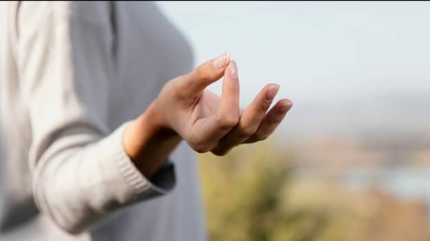 Hands gently cupped, symbolizing mindful breathing and a focus on inner peace. The background is soft and blurred, emphasizing the sense of calm.