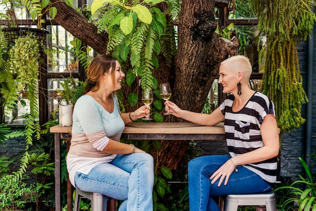 Two people engaged in an active listening conversation in a park. One person is speaking with open body language, while the other is listening attentively with a slight nod.