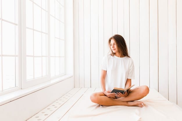 A person sitting comfortably on a cushion indoors, meditating with closed eyes and a calm expression, with soft natural light filtering through a window.