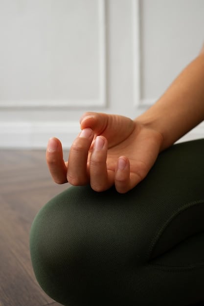 A close-up shot of a person's hands resting gently on their lap while meditating, with a soft, blurred background and a sense of peace and stillness.
