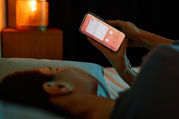 A person using a meditation app on their phone in a dimly lit room before going to sleep.