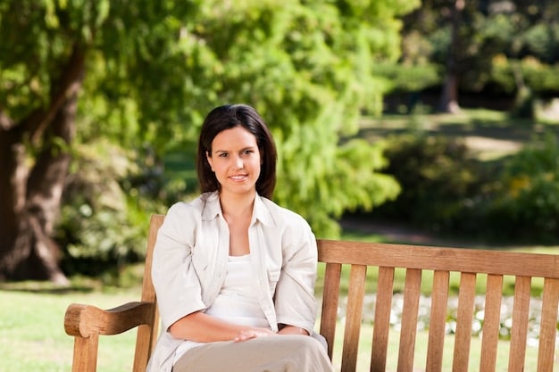 A woman caregiver sitting alone on a park bench, looking thoughtful and slightly sad. The image emphasizes the isolation and emotional weight that caregivers often experience.