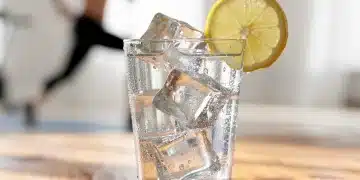Clear glass of water with lemon slice, symbolizing healthy hydration
