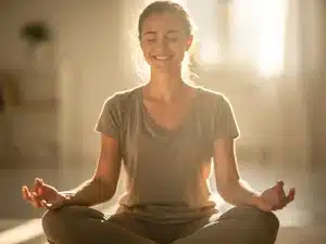 Person practicing mindful self-compassion meditation in a peaceful setting