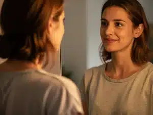 Reflective person seeing a more emotionally intelligent self in the mirror for personal growth